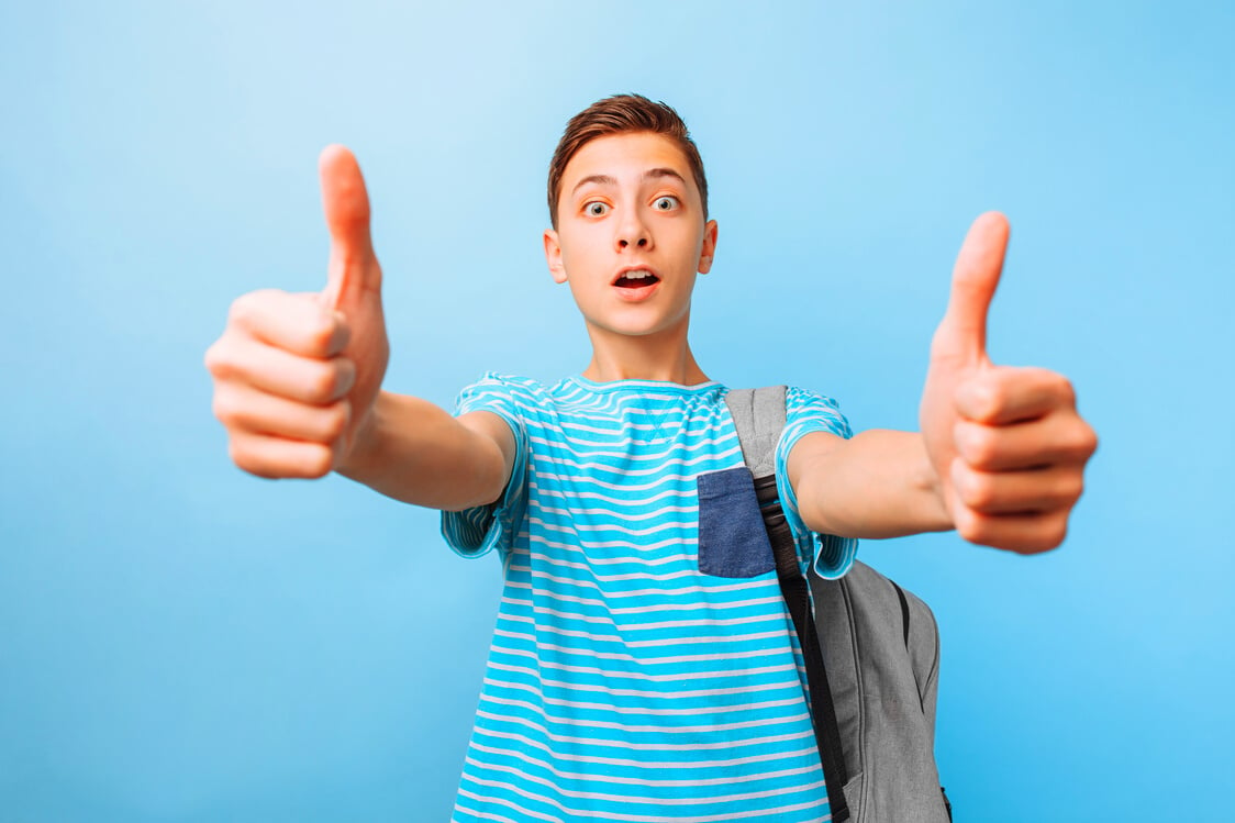 Cheerful Teen Guy Looking at Camera, Showing Thumb up